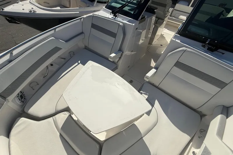 Slide: The Image of 2022 Pursuit DC 326 Dual Console boat interior with seating and table. - 25