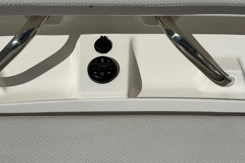 Slide: The Image of Close-up of 2022 Pursuit DC 326 Dual Console audio controls and chrome handles. - 26