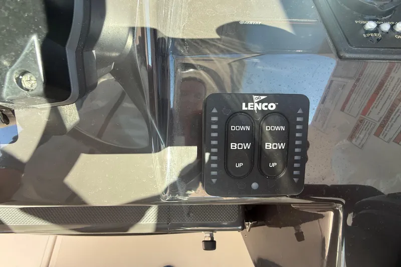 Slide: The Image of Control panel of a 2022 Pursuit DC 326 Dual Console boat with Lenco trim tab switches. - 29