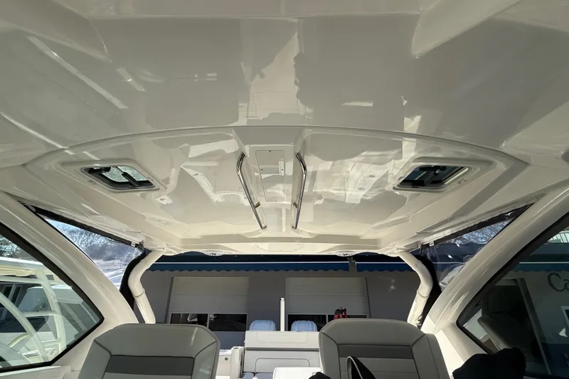 Slide: The Image of Interior view of 2022 Pursuit DC 326 Dual Console boat ceiling and seating. - 31