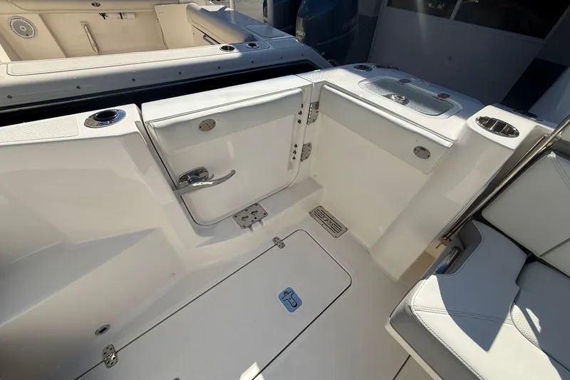 Slide: The Image of 2022 Pursuit DC 326 Dual Console boat interior with seating and storage compartments. - 35