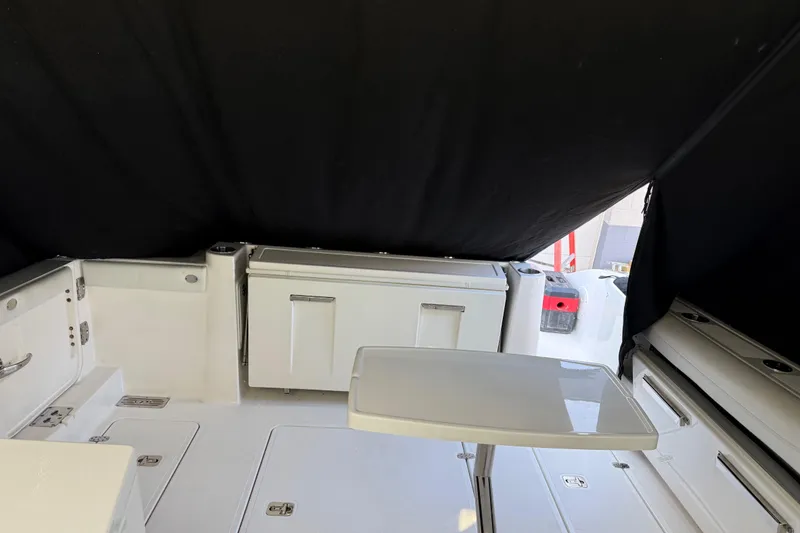 Slide: The Image of 2022 Pursuit DC 326 Dual Console interior with seating and storage compartments. - 37