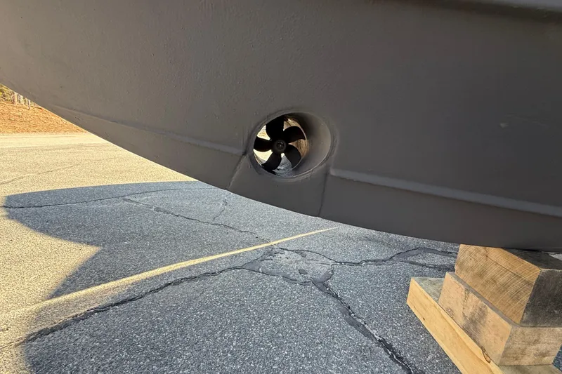 Slide: The Image of 2022 Pursuit DC 326 Dual Console boat hull with visible thruster detail. - 40