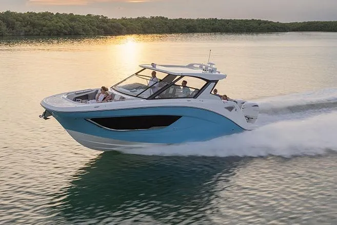 The Image of Manufacturer Provided Image: 2026 Hurricane SunDeck 3200 OB cruising on serene water at sunset. - 0