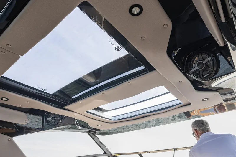 Slide: The Image of 2026 Hurricane SunDeck 3200 OB boat interior with sunroof and speaker system. - 10