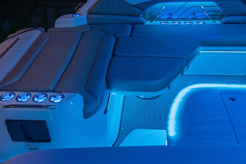 Slide: The Image of Luxurious interior of 2026 Hurricane SunDeck 3200 OB with ambient blue lighting. - 21
