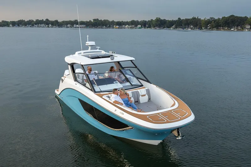 Slide: The Image of 2026 Hurricane SunDeck 3200 OB cruising on a serene lake with passengers onboard. - 22