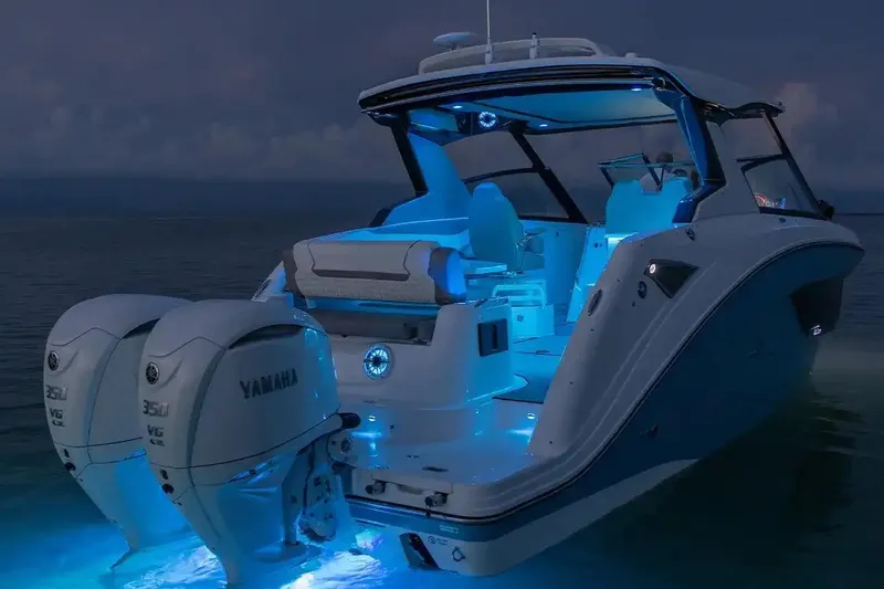 Slide: The Image of Manufacturer Provided Image: 2026 Hurricane SunDeck 3200 OB boat with illuminated interior and twin Yamaha engines at night. - 4