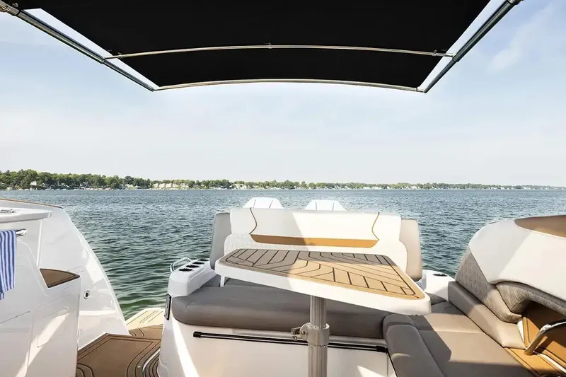 Slide: The Image of Manufacturer Provided Image: 2026 Hurricane SunDeck 3200 OB boat interior with lake view, featuring seating and table. - 5