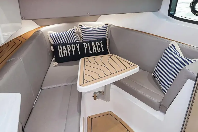 Slide: The Image of Manufacturer Provided Image: 2026 Hurricane SunDeck 3200 OB interior with cozy seating and decorative pillows. - 7