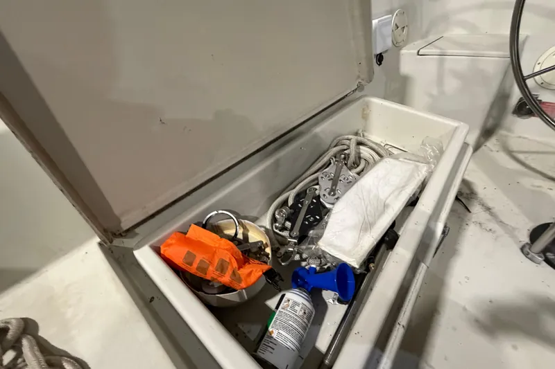 Slide: The Image of Open storage compartment on 1985 C&C 35 MK III sailboat with ropes and safety gear. - 12