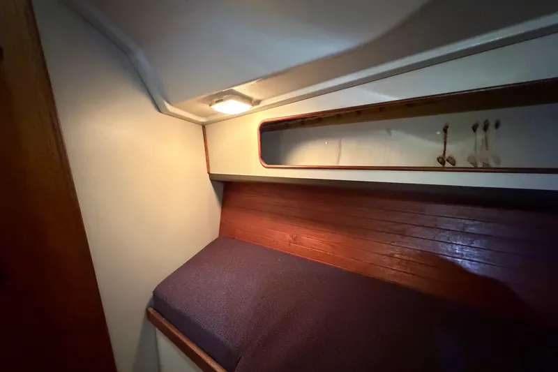 Slide: The Image of Cozy cabin interior of 1985 C&C 35 MK III sailboat with wooden accents and overhead lighting. - 18