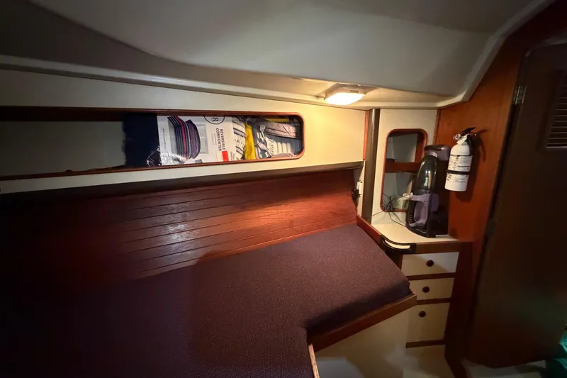 Slide: The Image of Cozy cabin interior of 1985 C&C 35 MK III sailboat with storage and fire extinguisher. - 19