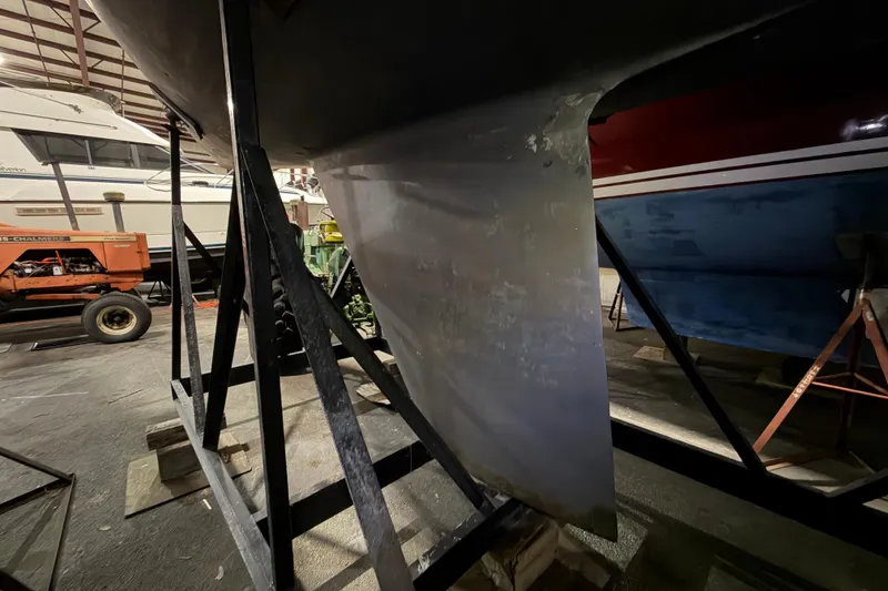 Slide: The Image of 1985 C&C 35 MK III sailboat keel in a storage facility with other boats. - 2