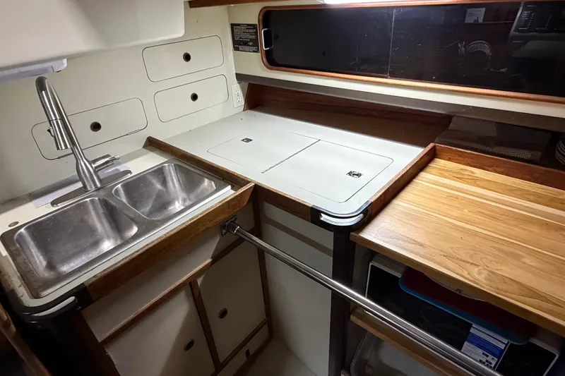 Slide: The Image of 1985 C&C 35 MK III yacht kitchen with double sink and wooden countertop. - 21