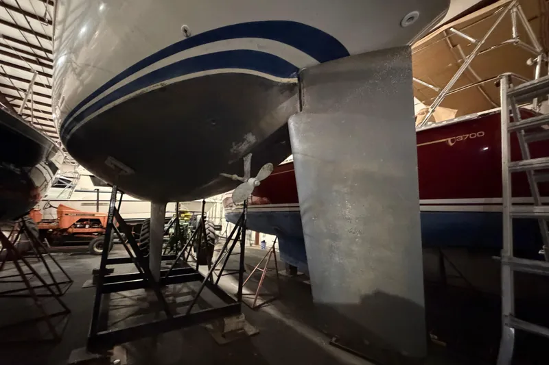 Slide: The Image of 1985 C&C 35 MK III sailboat in storage, showing keel and propeller. - 3