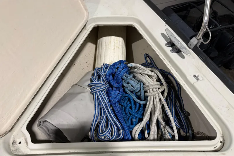 Slide: The Image of Storage compartment on 1985 C&C 35 MK III sailboat with coiled ropes. - 33