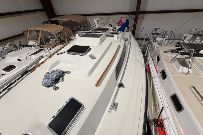 Slide: The Image of 1985 C&C 35 MK III sailboat in storage, showcasing deck and hatches. - 36