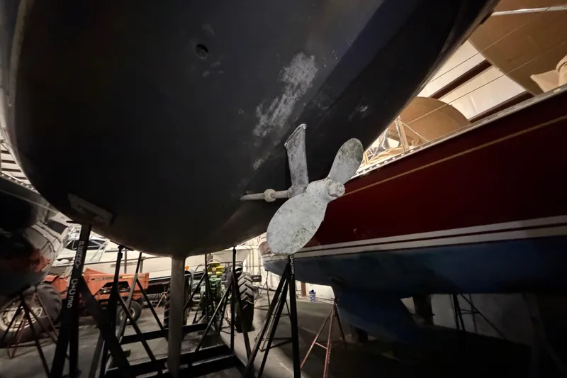 Slide: The Image of 1985 C&C 35 MK III sailboat in storage, showing propeller and hull. - 4