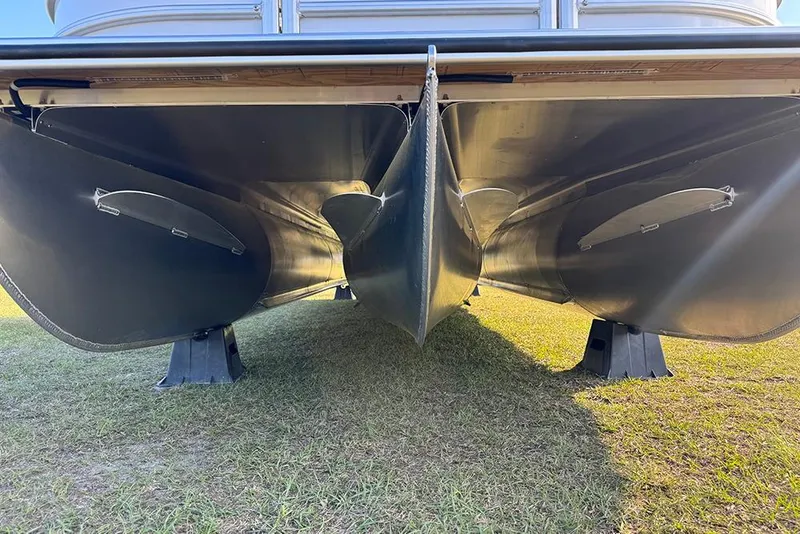 Slide: The Image of Underneath view of 2026 Bentley Pontoons 253 Elite Swingback DC on grass. - 10