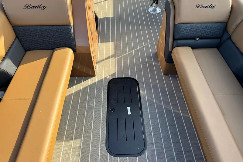 Slide: The Image of 2026 Bentley Pontoons 253 Elite Swingback DC interior with tan and gray seating. - 23