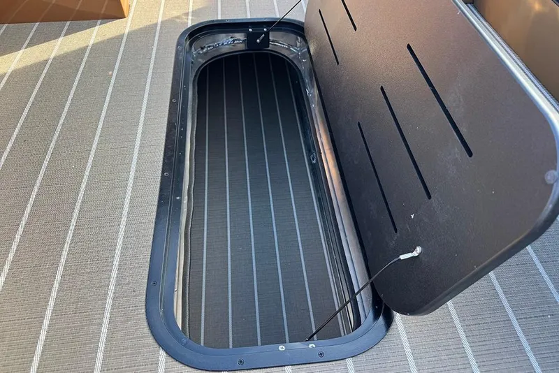 Slide: The Image of Open storage compartment on 2026 Bentley Pontoons 253 Elite Swingback DC boat. - 24