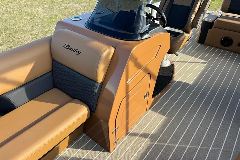 Slide: The Image of 2026 Bentley Pontoons 253 Elite Swingback DC interior with tan and black seating. - 25