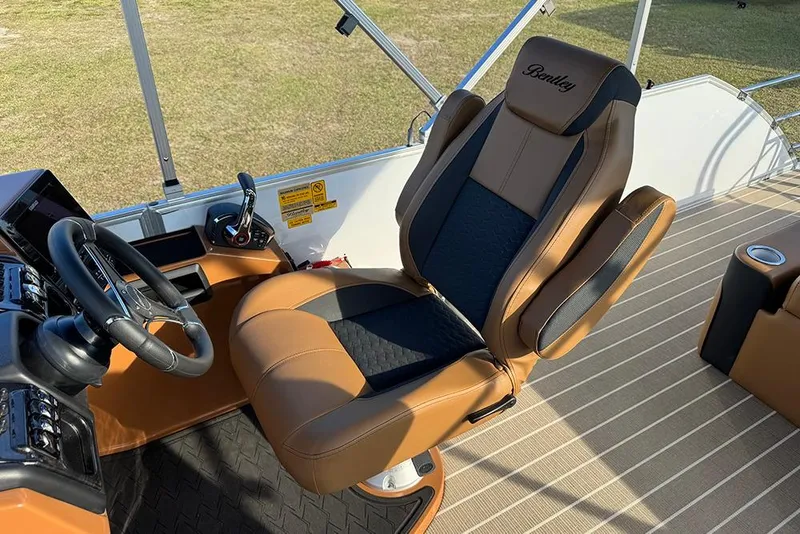 Slide: The Image of 2026 Bentley Pontoons 253 Elite Swingback DC captain's chair and steering console. - 30
