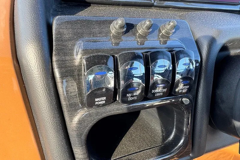 Slide: The Image of Control panel of 2026 Bentley Pontoons 253 Elite Swingback DC with labeled switches. - 33