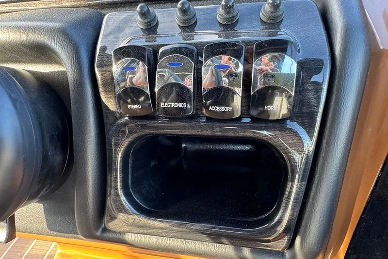 Slide: The Image of Control panel of 2026 Bentley Pontoons 253 Elite Swingback DC with labeled switches. - 34