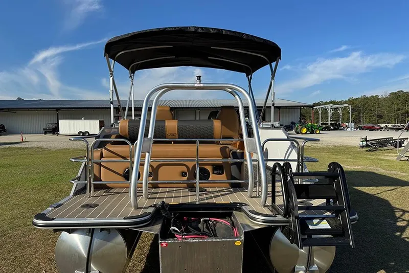 Slide: The Image of 2026 Bentley Pontoons 253 Elite Swingback DC, rear view, parked outdoors under blue sky. - 4