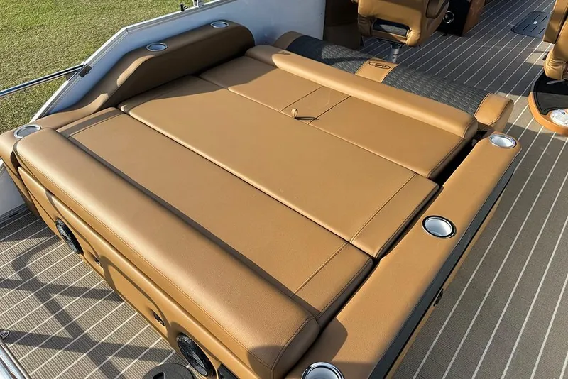 Slide: The Image of 2026 Bentley Pontoons 253 Elite Swingback DC with luxurious tan seating and cup holders. - 42