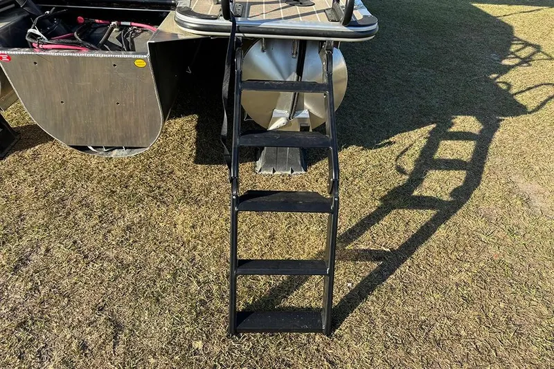 Slide: The Image of Rear view of 2026 Bentley Pontoons 253 Elite Swingback DC with ladder on grass. - 5