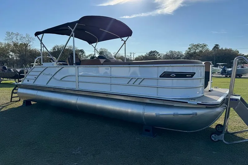 Slide: The Image of 2026 Bentley Pontoons 253 Elite Swingback DC on display, featuring sleek design and canopy. - 8