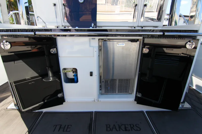 Slide: The Image of 2021 Jeanneau Leader 12.5 WA yacht kitchen area with storage and appliances. - 12