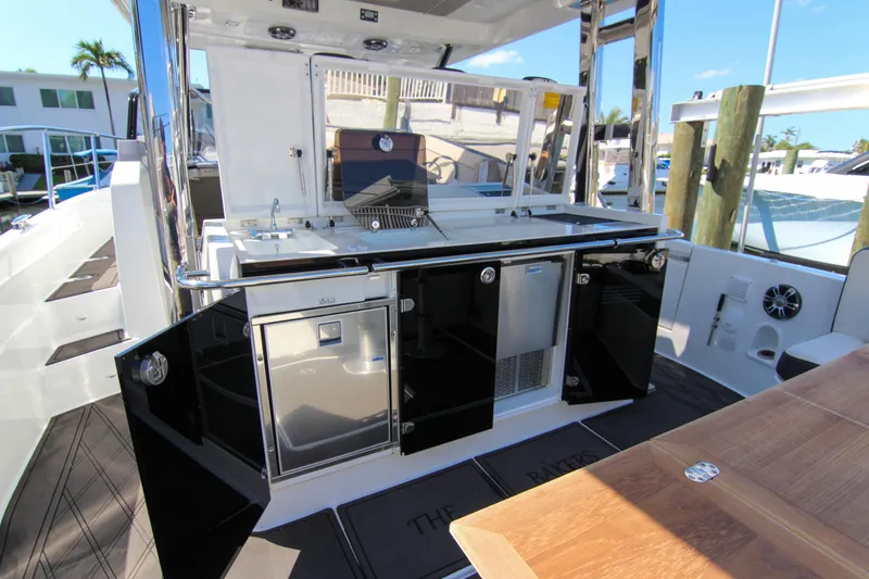 Slide: The Image of Outdoor kitchen on 2021 Jeanneau Leader 12.5 WA yacht with sleek black cabinetry. - 13
