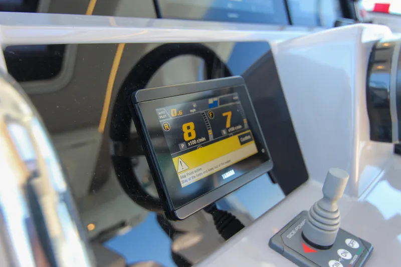 Slide: The Image of Dashboard of 2021 Jeanneau Leader 12.5 WA with Yamaha display and joystick controls. - 14