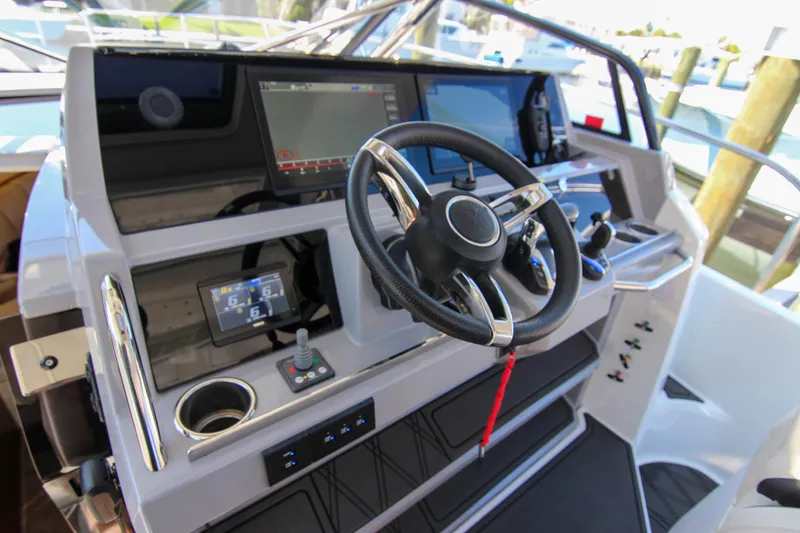 Slide: The Image of Cockpit of 2021 Jeanneau Leader 12.5 WA with modern steering and navigation controls. - 16