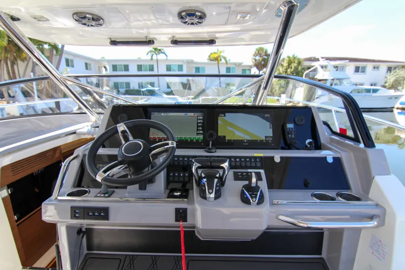 Slide: The Image of Cockpit of 2021 Jeanneau Leader 12.5 WA with modern navigation controls and steering wheel. - 19