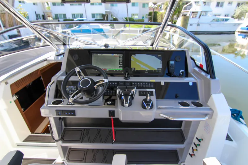 Slide: The Image of 2021 Jeanneau Leader 12.5 WA helm with modern controls and navigation display. - 20