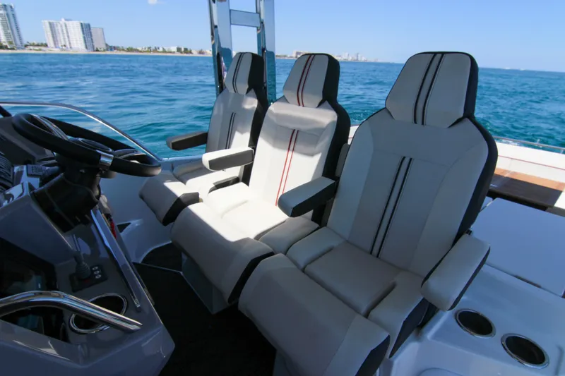 Slide: The Image of Luxury seating on 2021 Jeanneau Leader 12.5 WA boat, ocean view in background. - 27