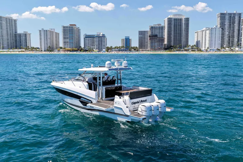 Slide: The Image of 2021 Jeanneau Leader 12.5 WA boat cruising near city skyline on blue ocean. - 3