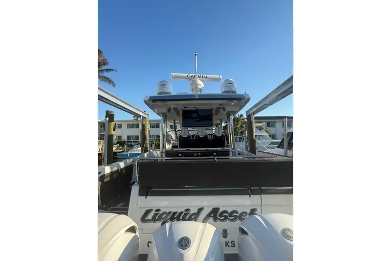 Slide: The Image of 2021 Jeanneau Leader 12.5 WA boat docked, featuring Garmin radar and twin engines. - 34