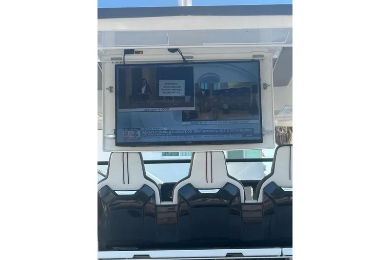 Slide: The Image of Flat-screen TV on 2021 Jeanneau Leader 12.5 WA boat, displaying news broadcast. - 35