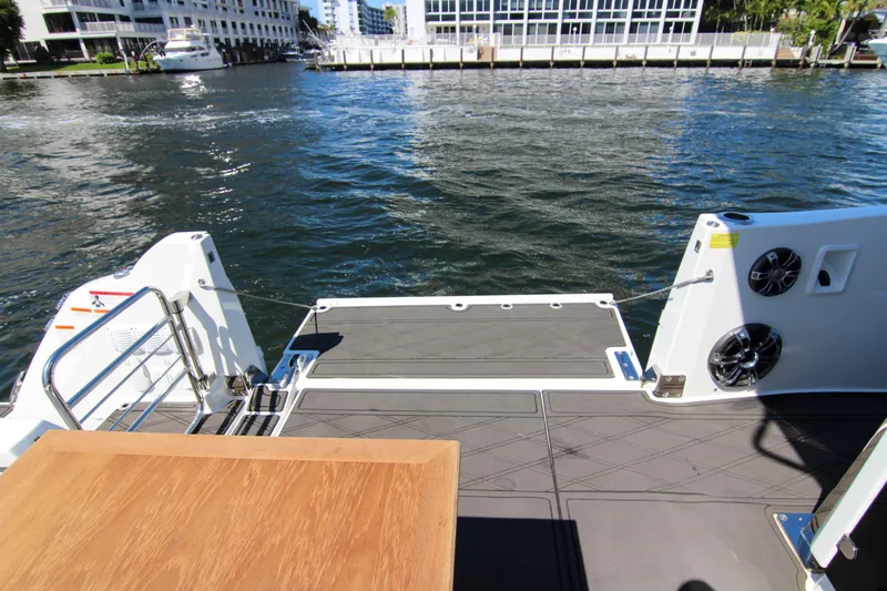 Slide: The Image of 2021 Jeanneau Leader 12.5 WA boat deck with waterfront view and modern amenities. - 38