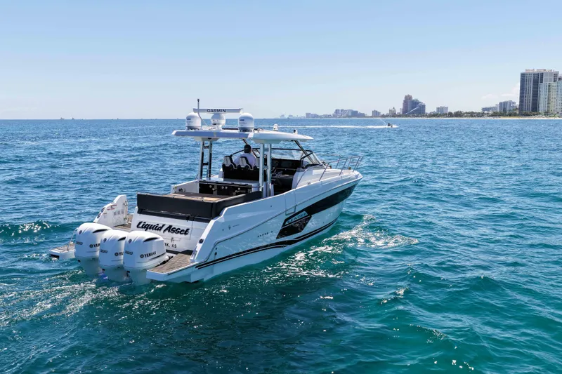 Slide: The Image of 2021 Jeanneau Leader 12.5 WA cruising on open water near city skyline. - 5