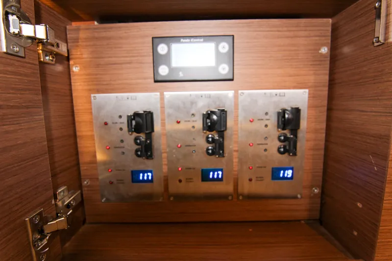 Slide: The Image of Electrical panel inside 2021 Jeanneau Leader 12.5 WA boat, featuring digital displays and switches. - 54