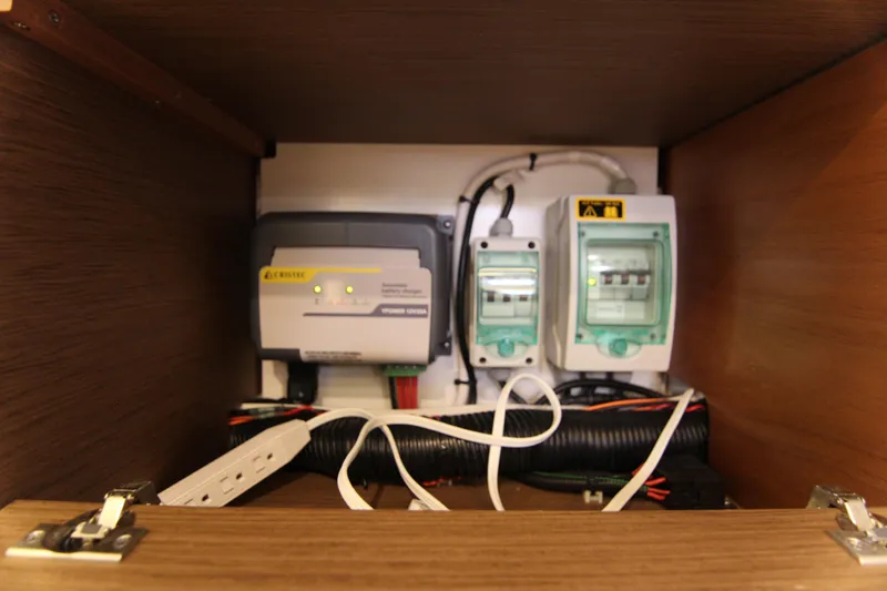 Slide: The Image of Electrical panel inside 2021 Jeanneau Leader 12.5 WA boat, featuring wiring and circuit breakers. - 55