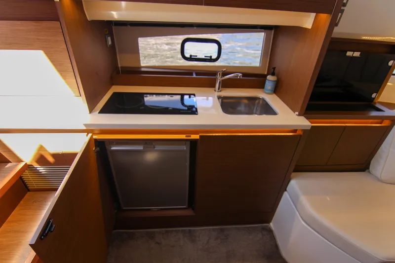 Slide: The Image of Interior of 2021 Jeanneau Leader 12.5 WA yacht kitchen with sink and stove. - 59