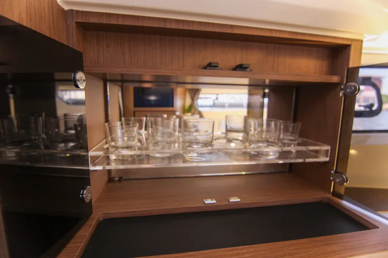 Slide: The Image of Interior of 2021 Jeanneau Leader 12.5 WA yacht with glassware storage. - 60